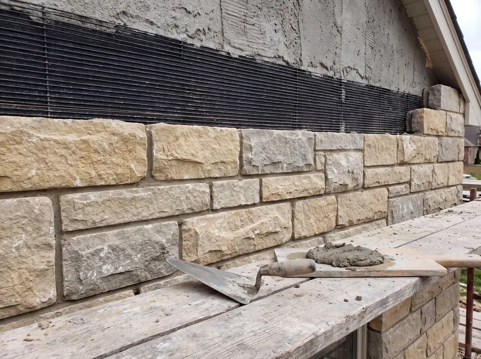 A stone veneer wall going up