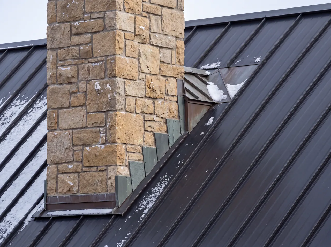 A chimney with a cricket on its uphill side and stepped counterflashing