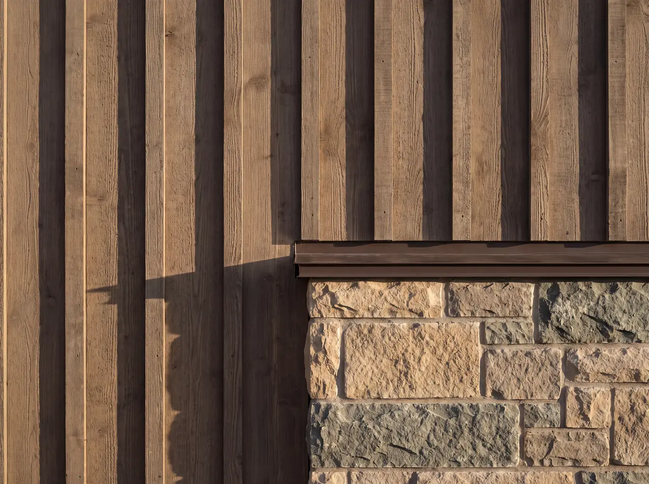 A timber post bearing on a stone base with a gap and a metal plate between them